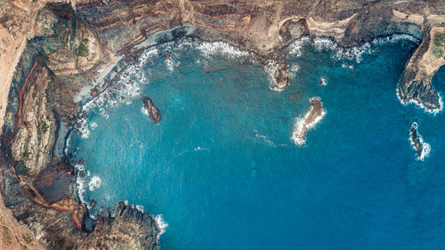 High angle view of rocks in sea