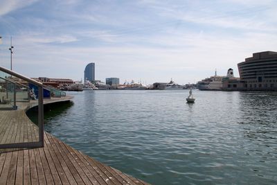 View of city by river against sky