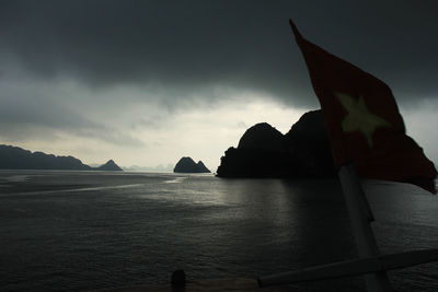 View of calm sea against mountain