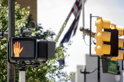 Low angle view of camera and traffic light on road