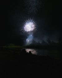 Low angle view of firework display at night