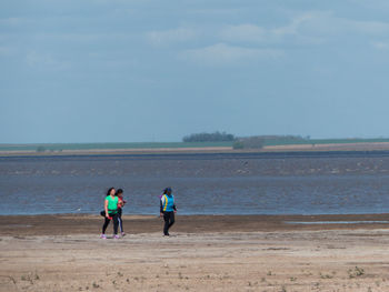 Full length of women walking on beach