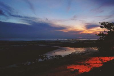 Scenic view of beach against sky during sunset