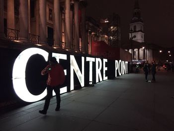 People in illuminated city at night