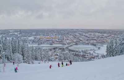 High angle view of people on snow covered landscape