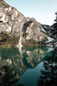 Scenic view of lake and mountains against clear sky