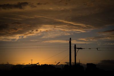 Low angle view of electricity pylon against sky