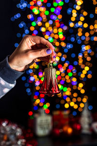 Midsection of person holding illuminated christmas lights