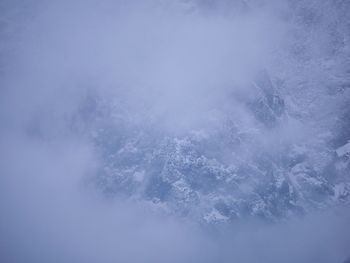 Scenic view of snow covered mountains against sky