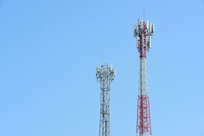 Low angle view of communications tower against clear blue sky