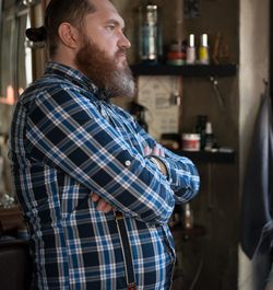 Thoughtful man standing in kitchen