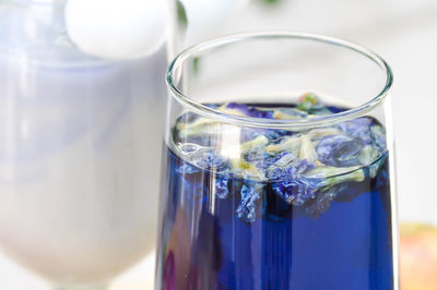Close-up of blue drink with flowers in drink