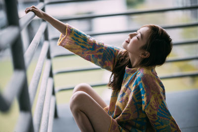 Rear view of young woman looking away