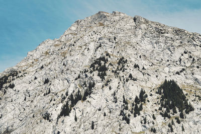 Low angle view of rock formation against sky