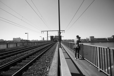 Railroad station platform against clear sky