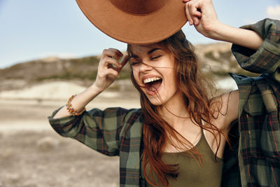 Side view of young woman looking at beach