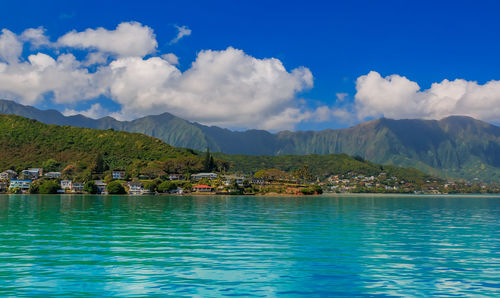 Scenic view of sea and mountains against sky