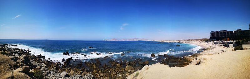 Panoramic view of beach against blue sky