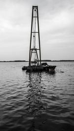 Dredge on river against sky