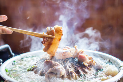 Close-up of hand holding meat