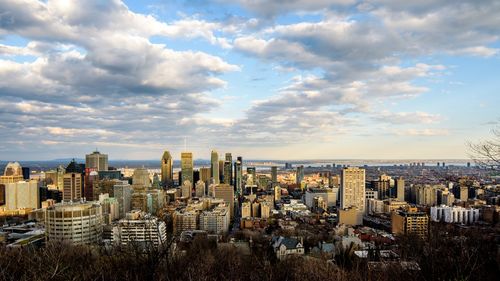 High angle view of buildings against cloudy sky