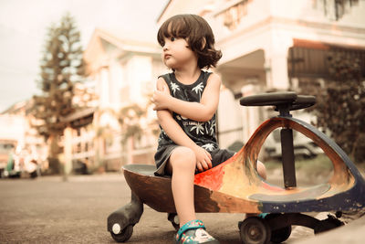 Boy looking away while sitting in car