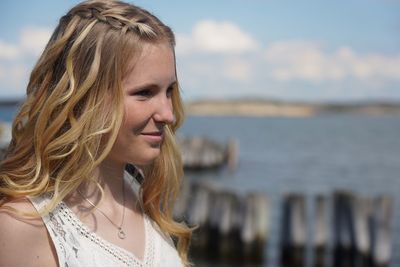 Portrait of smiling young woman at beach