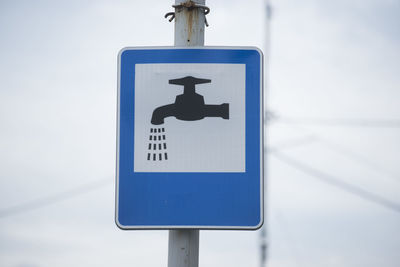 Close-up of arrow sign on road