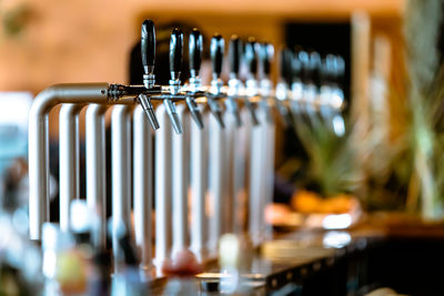 Close-up of faucets in bar