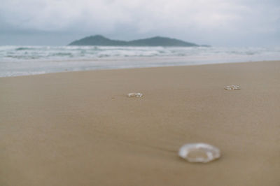 Close-up of sand on beach against sky