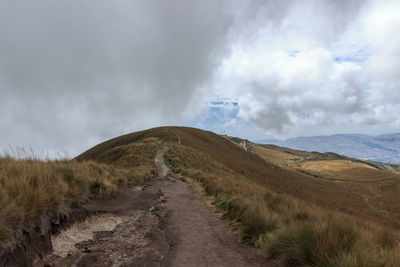 Scenic view of road amidst land against sky