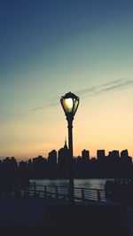 Street light against sky at dusk