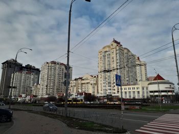 City street by buildings against sky