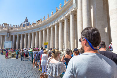 Rear view of people at historical building