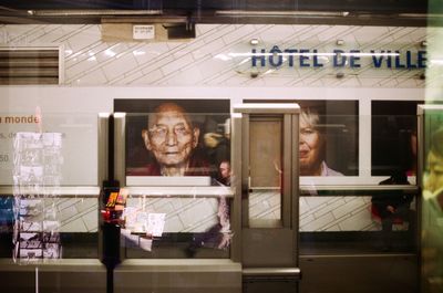 Digital composite image of man with reflection on glass window