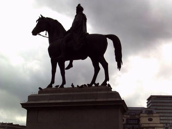 Statue against sky in city