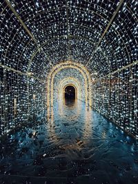 Illuminated tunnel seen through wet glass