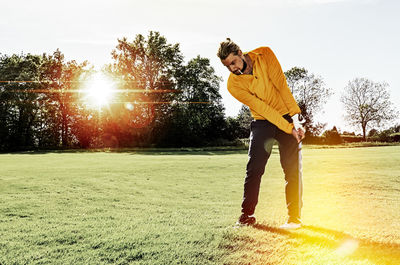 Full length of boy standing on golf course