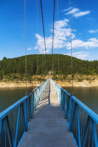 Footbridge against sky