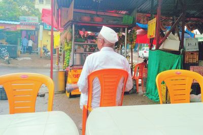 Rear view of man standing on street in city