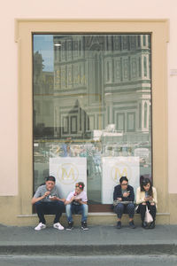 People sitting in front of building