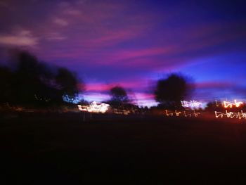 Silhouette trees against sky at night