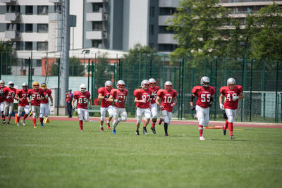 Group of people playing soccer on field