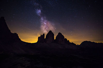 Scenic view of mountains against sky at night