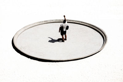 High angle view of man standing on sun dial