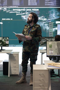 Rear view of man standing in office