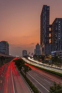 High angle view of light trails on road at sunset