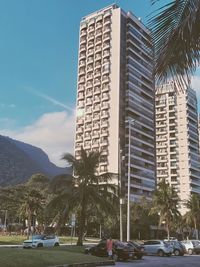 Street by modern buildings against sky