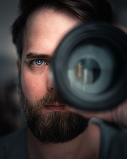 Close-up of man holding lens