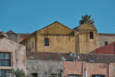 Low angle view of buildings against blue sky